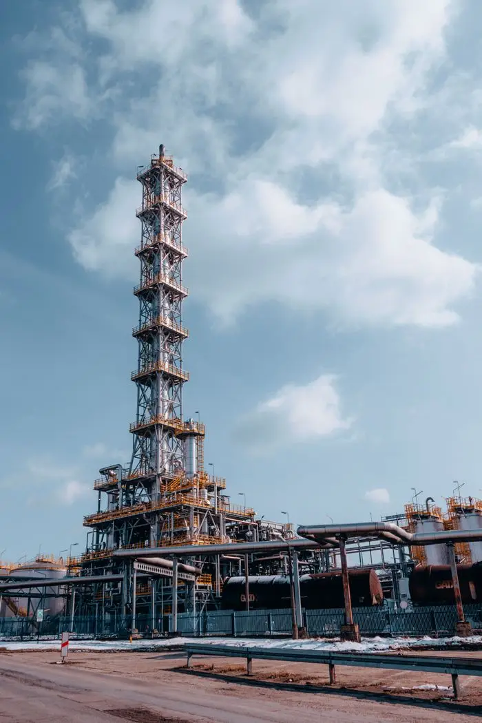THERMAL EXPANSION AND THE FORGOTTEN ISOLATION VALVE Vertical shot of an oil refinery tower against a blue sky in Trzebinia, Poland.