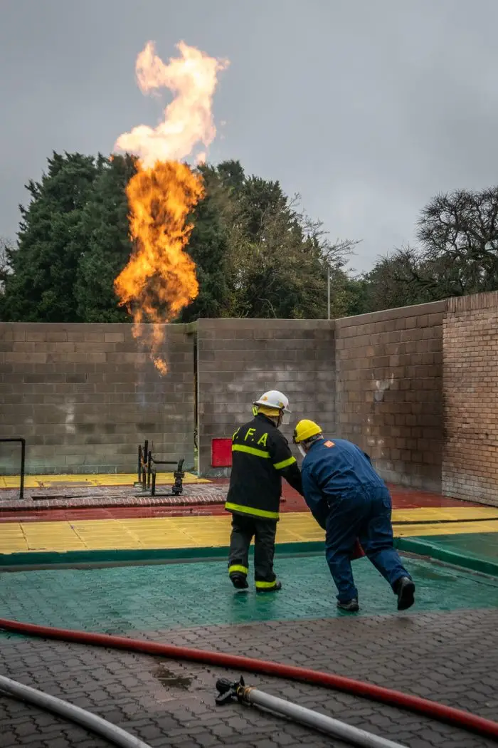 Firefighters practicing safety drills with controlled fire in Argentina.